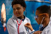 two boys listening to their hearts with stethoscopes